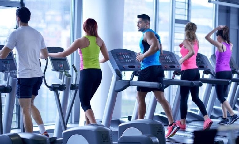 Group of people running on treadmills